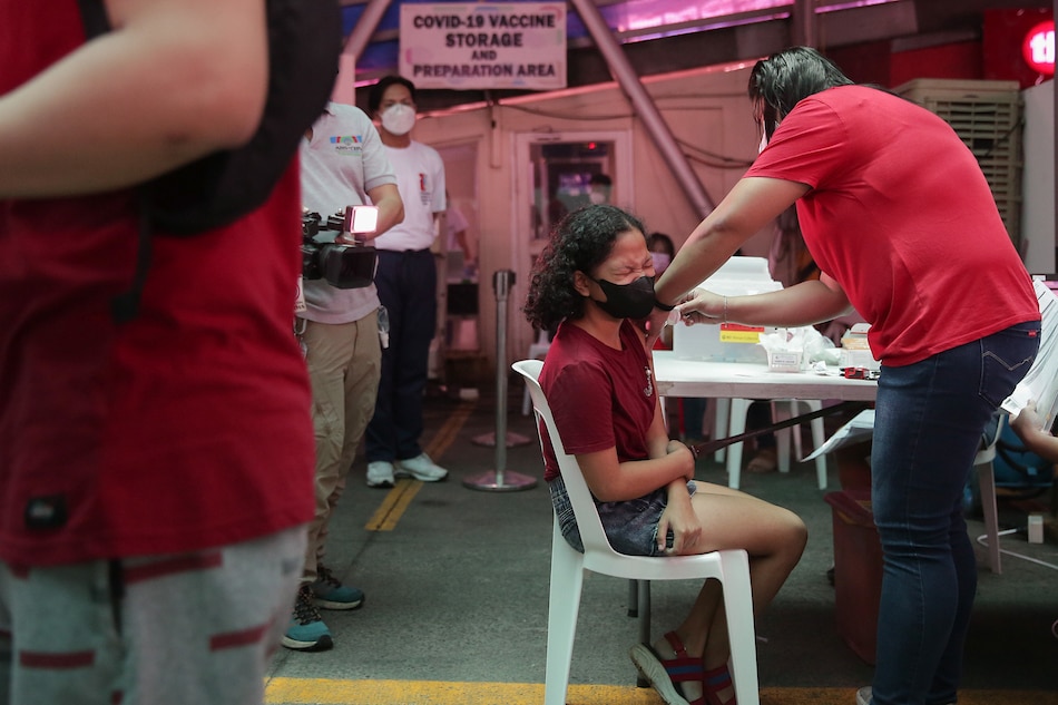 Health workers administer booster shots to minors at the Cardinal Santos Medical Center vaccination site in San Juan City on June 23, 2022. George Calvelo, ABS-CBN News
