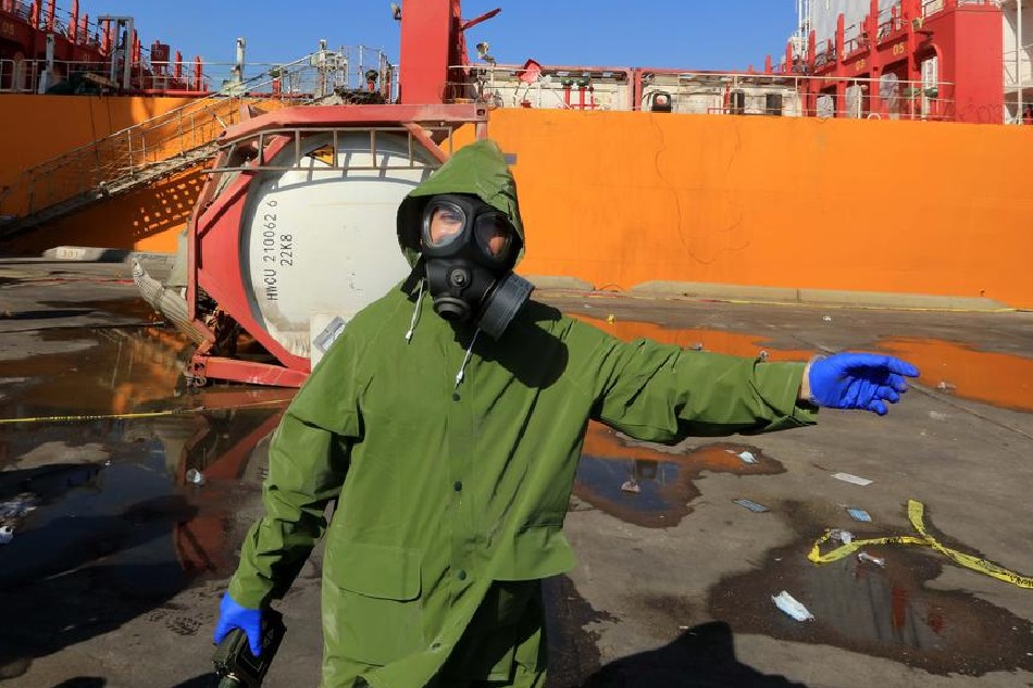 Authorities investigate the scene in the aftermath of the explosion of a tank containing large amounts of the toxic chlorine gas, at the port in Aqaba, Jordan, on June 28, 2022. Mohammad Ali, EPA-EFE