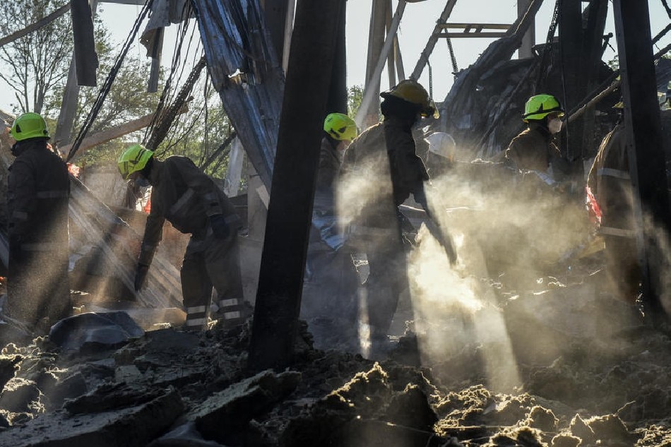 Firefighters clean the rubble of the destroyed Amstor shopping mall in Kremenchuk, Poltava Oblast, Ukraine, on June 28, 2022. Oleg Petrasyuk, EPA-EFE/file
