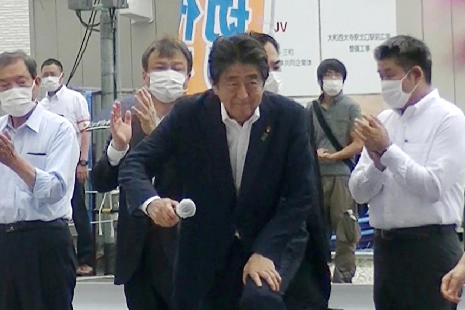 Former Japanese Prime Minister Shinzo Abe (C) steps up to podium to speak to voters in support of his party's candidate during an Upper House election campaign outside Yamato-Saidaiji Station of Kintetsu Railway in Nara, Japan, on July 8, 2022, just before he was shot. The suspect Tetsuya Yamagami (2-R), 41, who was arrested by police, is standing behind of Abe as Abe starts to speak. EPA-EFE/JIJI PRESS