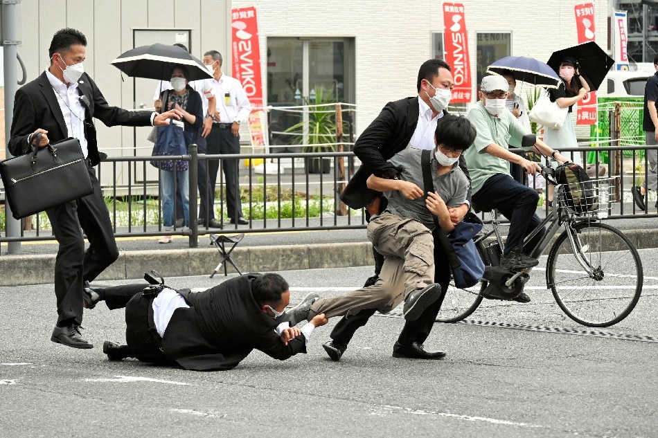 Security police tackle a suspect who is believed to have shot former Prime Minister Shinzo Abe outside Yamato-Saidaiji Station in Nara, Japan, 08 July 2022. The suspect identified as Tetsuya Yamagami was arrested and taken into custody. According to Japan's national broadcaster, former Prime Minister Shinzo Abe died of his injuries on 08 July 2022, hours after being shot during an Upper House election campaign act to support a party candidate, outside Yamato-Saidaiji railway station in Nara, western Japan. EPA-EFE/The Asahi Shimbun