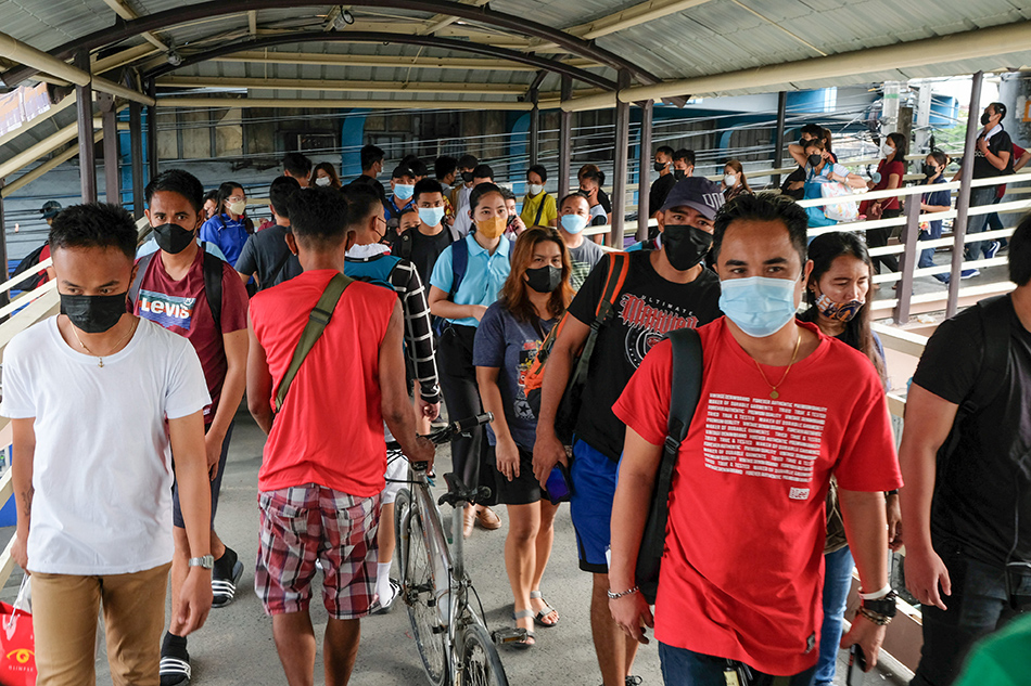 Commuters line up to ride the EDSA Bus Carousel at the Roosevelt station in Quezon City on July 1, 2022. George Calvelo, ABS-CBN News