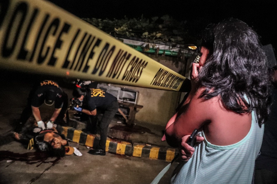 A relative of a suspected drug personality watches as police crime scene operatives (SOCO) process the crime area in manila on June 16, 2017. Jonathan Cellona, ABS-CBN News