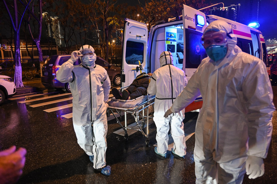 Medical workers arrive with a patient at the Wuhan Red Cross Hospital in Wuhan on January 25, 2020, the epicenter of a spiraling viral outbreak that was slowly spreading around the around the world, as millions spent their normally festive Lunar New Year holiday. Hector Retamal, AFP