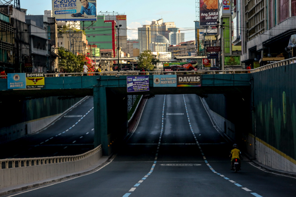 A lone rider traverses the normally busy commercial district of Quiapo in Manila on March 24, 2020, devoid of traffic at the start of the lockdown in the capital region imposed to combat the threat of COVID-19. Fernando G. Sepe Jr., ABS-CBN News