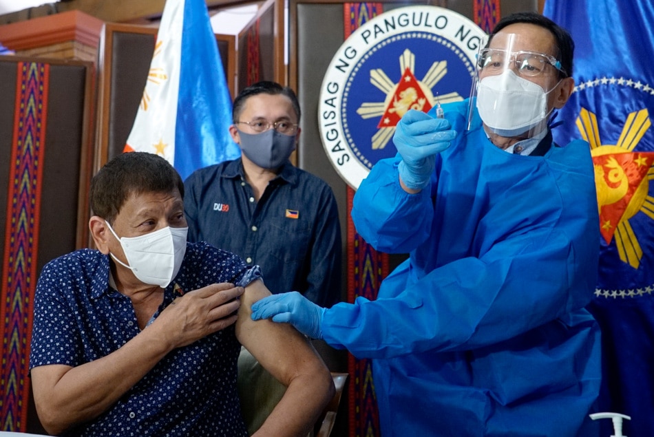 Then-President Duterte receives his second shot of Covid-19 vaccine administered by then-Health Secretary Francisco Duque III prior to his talk to the people at the Malacañang Palace in Manila on July 12, 2021. King Rodriguez, Presidential Photo