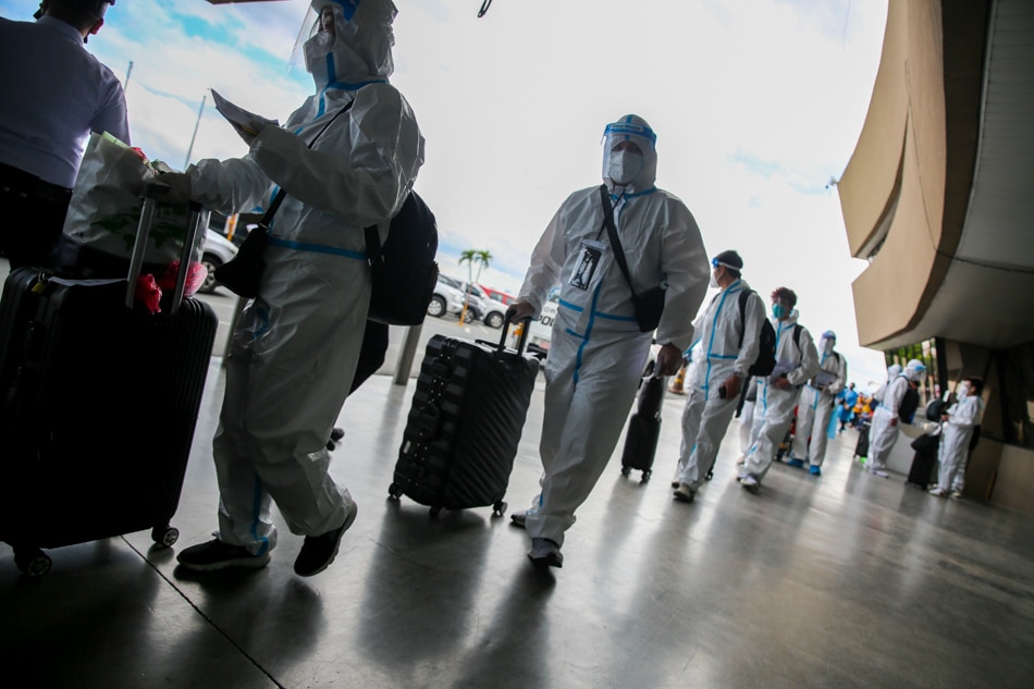 Overseas Filipino Workers (OFWs) wear personal protective suits at the departure area of the Ninoy Aquino International Airport on April 7, 2022. A large portion percentage of OFWs during the pandemic came from the health care sector as demand for personnel abroad spiraled. Jonathan Cellona, ABS-CBN News