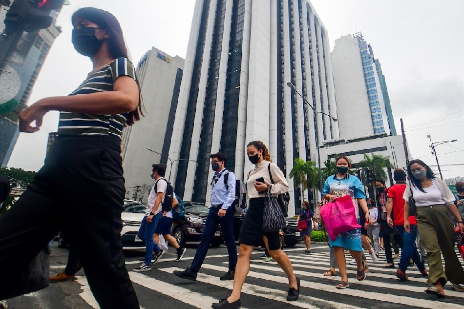 Pedestrians walk at a crossing in Makati City on July 12, 2022. Mark Demayo, ABS-CBN News