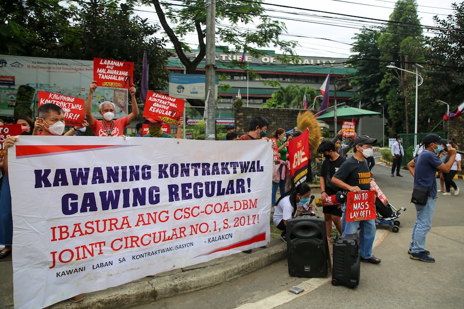 Government workers belonging to the Confederation for Unity, Recognition, and Advancement of Government Employees (COURAGE) and Kawani laban sa Kontraktwalisasyon stage a protest in front of the National Housing Authority (NHA) gate, at the Elliptical Circle in Quezon City, on June 24, 2022. Jonathan Cellona, ABS-CBN News/File 