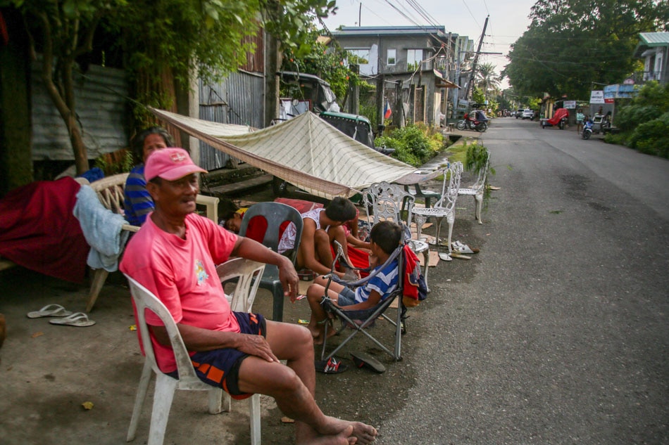 Residents stay at a makeshift shelter after spending the night outside their home in Bangued, Abra Thursday. Residents were advised to stay outside their homes due to aftershocks following a 7.0 magnitude earthquake on July 27. Jonathan Cellona, ABS-CBN News