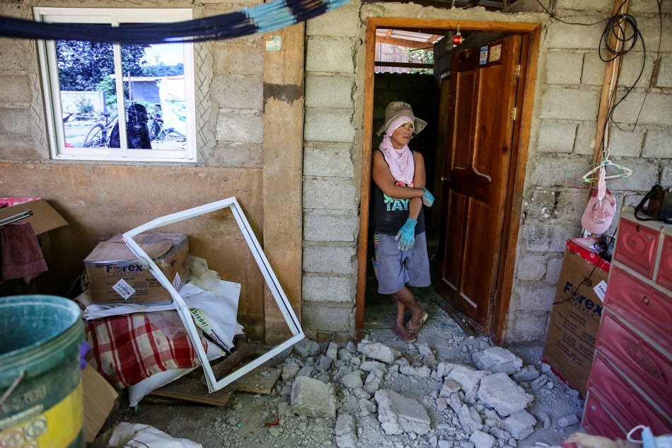 Imelda and Fernando Taa pause as they clear some debris from their house destroyed by the earthquake, as residents of Nagtipulan in Lagangilang, Abra react to their situation as they view their homes and belongings on July 29, 2022. Jonathan Cellona, ABS-CBN News