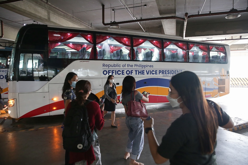 Parañaque Integrated Terminal Exchange (PITX) employees pose for photos with one of the buses during the launch of the “Peak Hours Augmentation Bus Service - Libreng Sakay” on Aug. 3, 2022. Two buses will be operational in Metro Manila through the EDSA bus carousel route, according to the Office of the Vice President. George Calvelo, ABS-CBN News