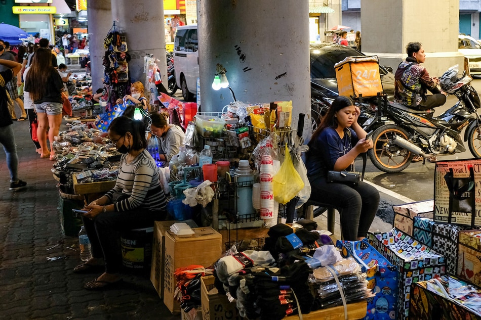 A street vendor sells goods on a sidewalk along Avenida in Manila on July 21, 2022. The health department reported 2,828 new COVID-19 cases today, the highest daily tally in more than five months since February 13. George Calvelo, ABS-CBN News