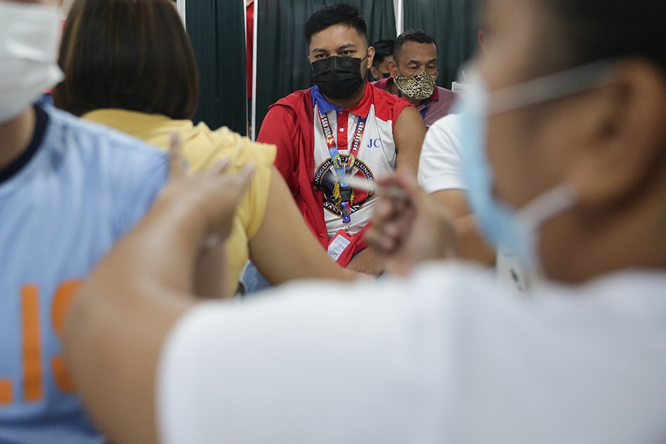 Eligible San Juan residents line up to get their second booster shots against COVID-19 at the VMall, Greenhills on July 28, 2022. George Calvelo, ABS-CBN News
