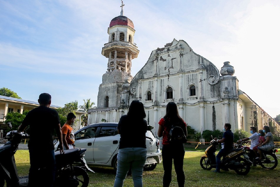 Devotees attend the early morning mass outside the Santa Catalina de Alejandria Parish Church in Tayum, Abra on July 31, 2022, 4 days after a 7.0-magnitude quake jolted Abra last July 27. Jonathan Cellona, ABS-CBN News