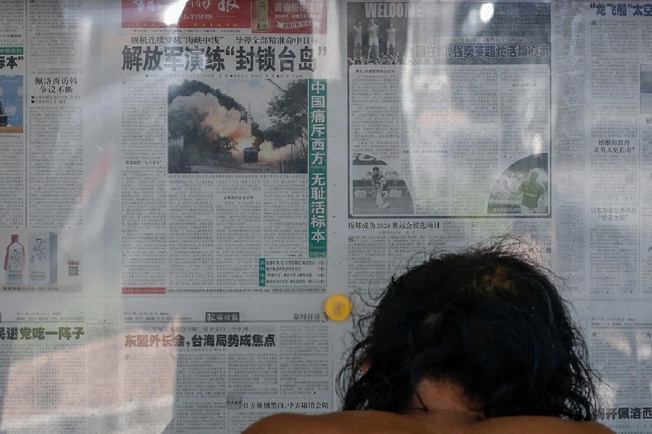 A man reads newspapers on a bulletin board in Beijing, China, on August 5, 2022. Mark R. Cristino, EPA-EFE