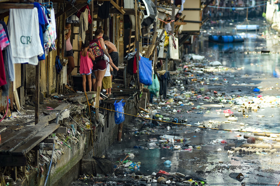  Residents are seen along the banks of the estero as the Pasig River Rehabilitation Commission (PRRC) relocates informal settler families (ISFs) of the Estero de Magdalena in Binondo, Manila on June 20, 2019. The project is part of the rehabilitation effort of the government to clean up Manila Bay and waterways within the city. The ISFs are bound to be relocated at Barangay Cabuco, Trece Martires, Cavite to ensure their safety for the upcoming rainy season. George Calvelo, ABS-CBN News
