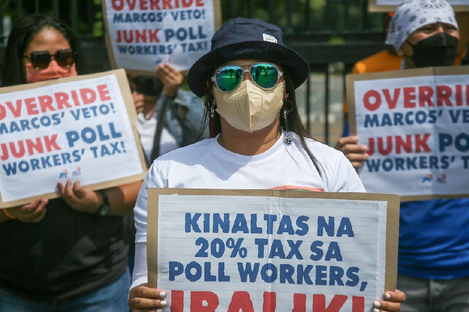 Members of the Alliance of Concerned Teachers (ACT) hold a protest in front of the House of Representatives in Quezon City on Wednesday, urging lawmakers to override the decision of President Marcos, Jr. to veto a bill that would provide tax exemptions on the election workers' service honoraria. Marcos opted to give cash aid to election workers citing possible confusion and 'leakage' with the imposition of the said tax exemption. Jonathan Cellona, ABS-CBN News
