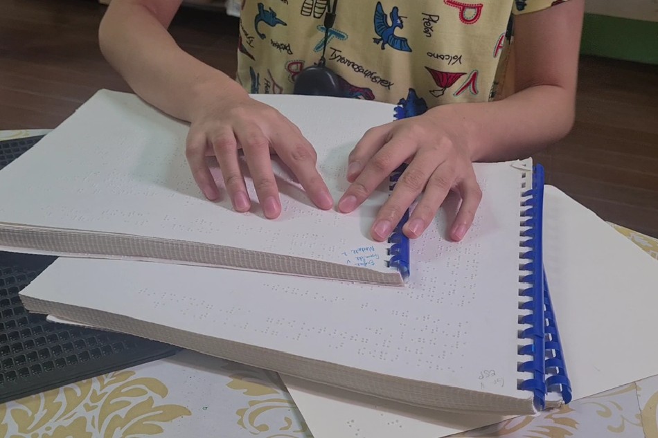 A learner with special needs uses Braille at Batino Elementary School. Photo courtesy of Batino Elementary School/ABS-CBN News file