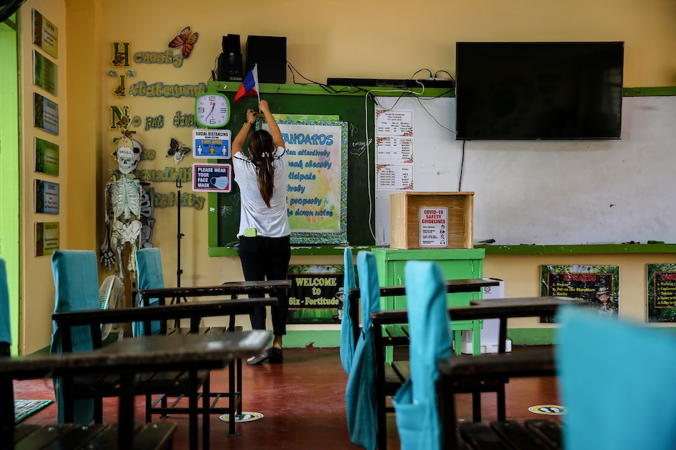 A teacher decorates her classroom in preparation for the admission process for incoming elementary school students at the Center of Excellence in Public Elementary Education - CENTEX Manila along J. Abad Santos corner C.M. Recto Streets, Tondo, on July 13, 2022. ABS-CBN News/File