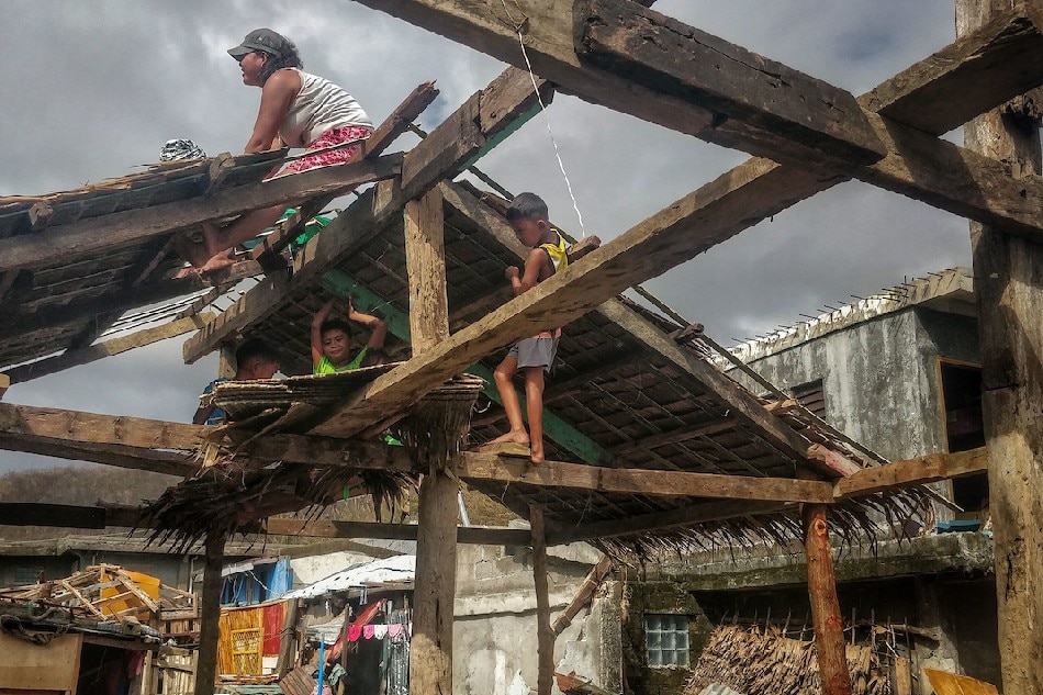Members of the Bora family on Nov. 14, 2020 rebuild their house along the coastal area of Barangay Agban in Baras, Catanduanes after it was destroyed by Super Typhoon Rolly and Typhoon Ulysses. Hundreds of thousands of Filipinos were displaced as Typhoon Ulysses brought strong winds and torrential rains from Nov. 11 that inundated large swath of lands in the Bicol region, National Capital Region, central and northern Luzon. Vincent Go, ABS-CBN News/File 