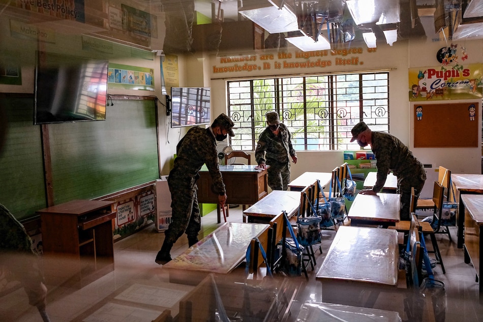 Uniformed personnel participate during the Brigada Eskwela Kickoff inside the Comembo Elementary School in Makati on August 10, 2022. George Calvelo, ABS-CBN News/file