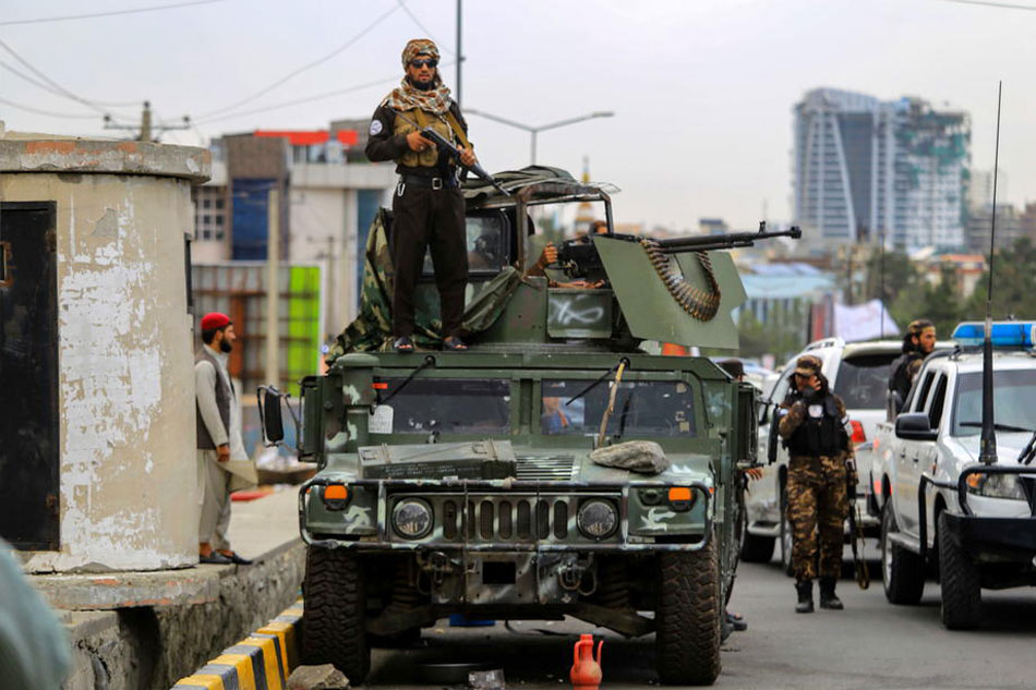 Taliban stand guard near a mosque in Kabul, Afghanistan, on August 8, 2022. Stringer, EPA-EFE/file