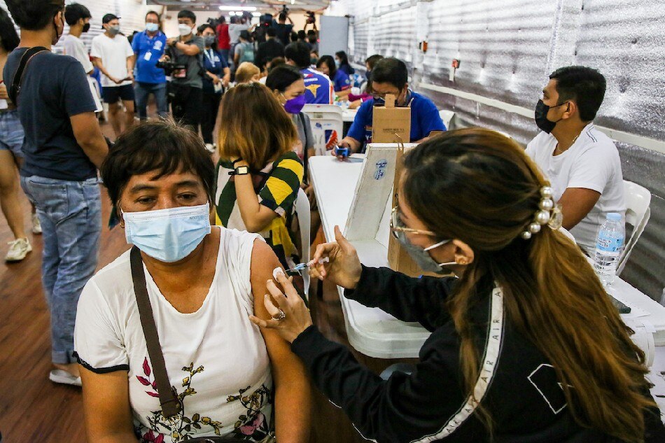 Residents, mostly senior citizens, at the Marikina Sports Complex wait and receive their COVID-19 booster shot in Marikina City on July 22, 2022. Jonathan Cellona, ABS-CBN News/file