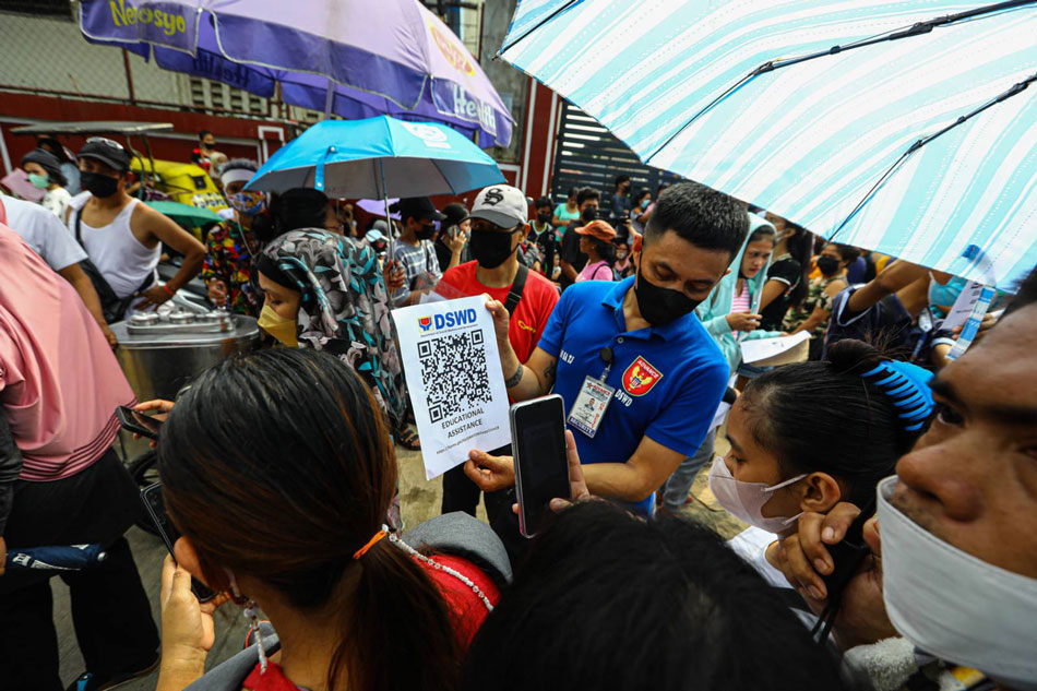 Thousands of people rush to the Department of Social Welfare and Development headquarters in Quezon City on August 20, 2022 to avail of the educational assistance being offered ahead of the first day of classes. Only those registered online have been permitted to claim their assistance forcing some to register and get their online DSWD QR registration forms outside the DSWD office. Jire Carreon, ABS-CBN News