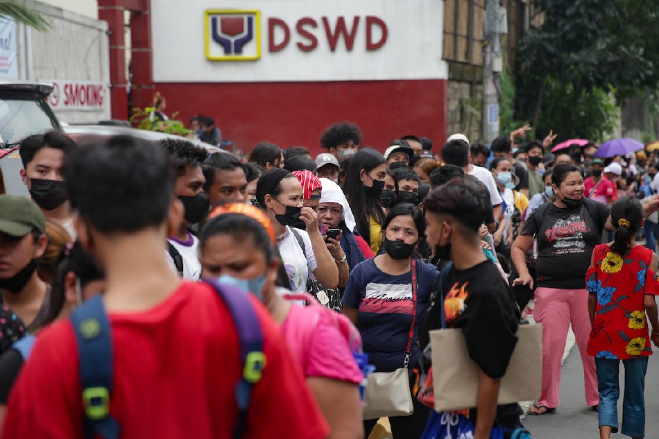 People queue at the DSWD main office in Quezon City to avail of the department's educational cash assistance for indigent students on August 20, 2022. George Calvelo, ABS-CBN News