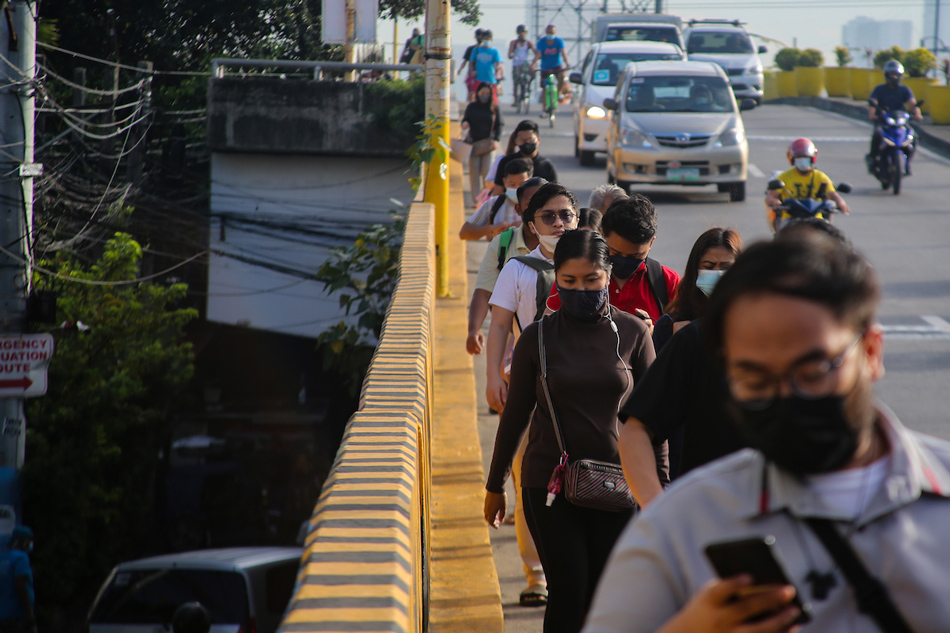 People walk in the business district of Makati City on March 3, 2022. Jonathan Cellona, ABS-CBN News/File