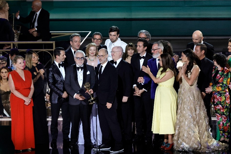 Jesse Armstrong (C, holding trophy) and cast and crew of 'Succession' accept the Outstanding Drama Series award onstage during the 74th Primetime Emmys at Microsoft Theater on September 12, 2022 in Los Angeles, California. Kevin Winter, AFP