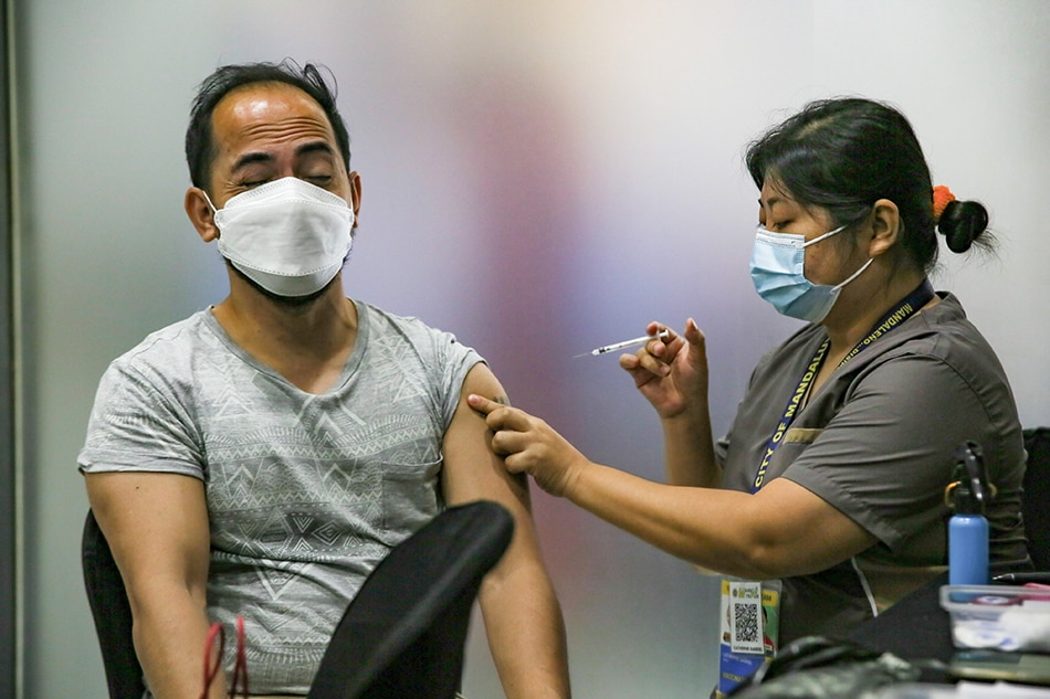 : A BPO employee receives his COVID-19 booster shot at Rockwell Business Center in Mandaluyong City on Sept. 7, 2022. Jonathan Cellona, ABS-CBN News
