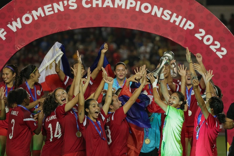 Members of the Philippine Women's National Football Team celebrate after winning the country’s first ASEAN Football Federation (AFF) Women's Championship title at the Rizal Memorial Stadium in Manila on July 17, 2022. George Calvelo, ABS-CBN News