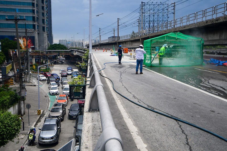 A demonstration of hydro demolition goes underway along the EDSA-Kamuning southbound flyover, as it closes to the public on June 26, 2022 to fix large cracks and potholes that would last for a month. Mark Demayo, ABS-CBN News/File