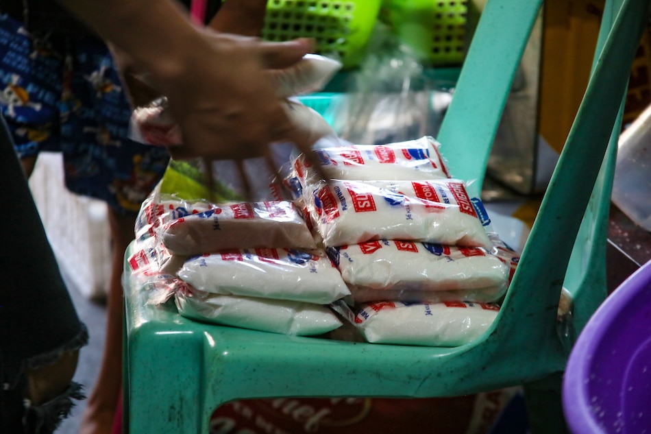 A vendor arranges her stock of sugar at a store in Barangka St., in Mandaluyong city on August 29, 2022. Jonathan L. Cellona, ABS-CBN News