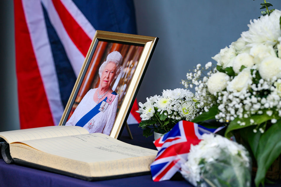 A portrait of Britain’s Queen Elizabeth II is displayed next to a condolence book by the gate o the British Embassy Manila in Taguig City on Sept. 9, 2022 after the monarch’s death. Jonathan Cellona, ABS-CBN NewsA portrait of Britain’s Queen Elizabeth II is displayed next to a condolence book by the gate o the British Embassy Manila in Taguig City on Sept. 9, 2022 after the monarch’s death. Jonathan Cellona, ABS-CBN News
