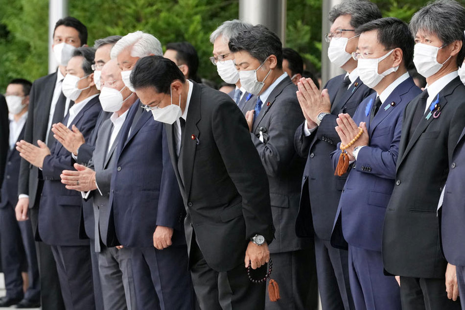 Japan's Prime Minister Fumio Kishida (C) and other officials bow as a hearse carrying the body of Japan's former Prime Minister Shinzo Abe makes a brief visit to the Prime Minister's Office in Tokyo, Japan, 12 July 2022, after the funeral for Abe was held at Zojoji Temple. Abe was shot dead on 8 July by a 41-year-old former member of the Japan Maritime Self-Defense Force, in Nara, western Japan, during an Upper House election campaign to support a candidate of his ruling party. EPA-EFE/Eugene Hoshiko / POOL
