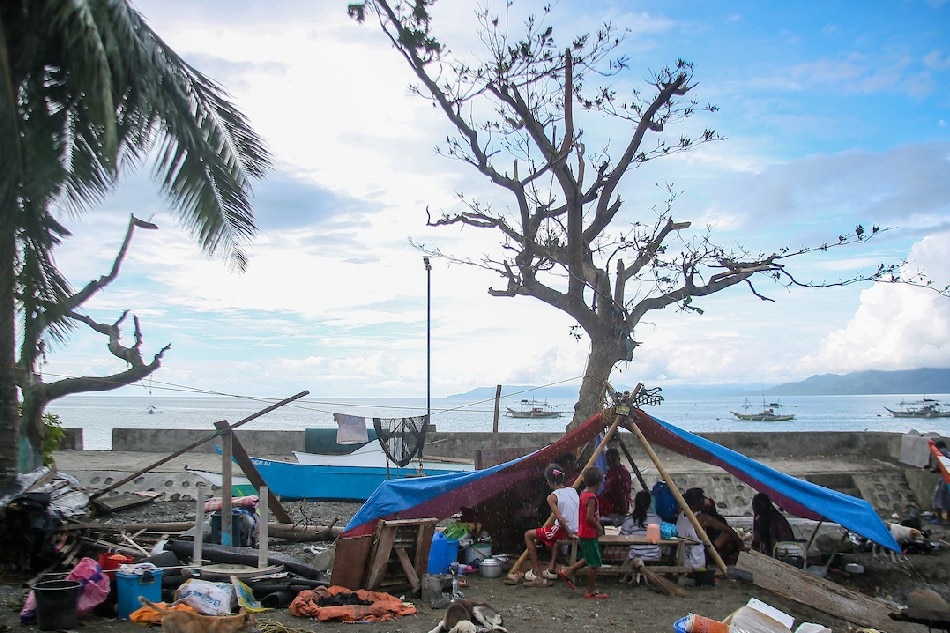 The Sacare family eats their meals under a tent set up beside their home in Barangay Paltic in Dingalan Aurora on September 27, 2022, days after super typhoon Karding made landfall in the area. Jonathan Cellona, ABS-CBN News/File 