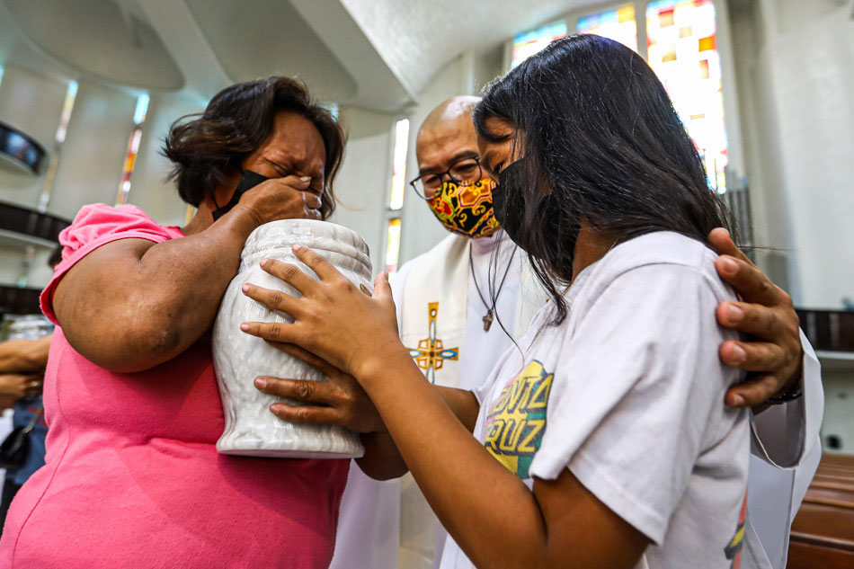 Fr. Flavie Villanueva, SVD condoles with family members of alleged extra-judicial killing (EJK) victims during a prayer service and the turnover of urns at the Shrine of the Divine Word, Christ the King Mission Seminary in Quezon City on Sept. 28, 2022. The service is part of Program Paghilom, a program that aims to help those orphaned by EJKs rebuild and re-create their lives. Jire Carreon, ABS-CBN News