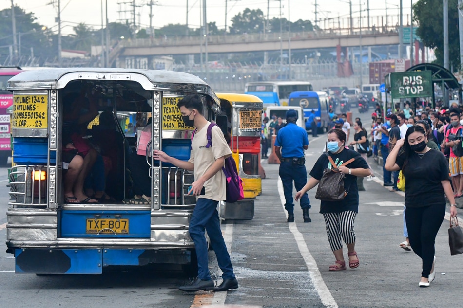 Commuters wait for a ride along Commonwealth Avenue in Quezon City. Mark Demayo, ABS-CBN News/File