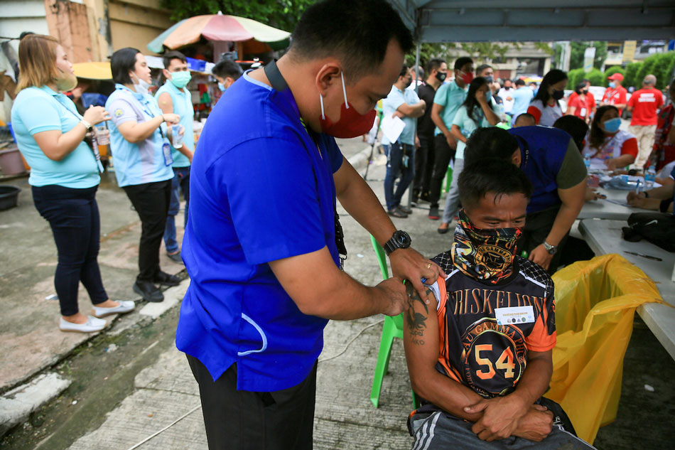 A health worker inoculates a homeless person with a COVID-19 booster shot along Scout Santiago Street in Quezon City on September 29, 2022. Jonathan Cellona, ABS-CBN News