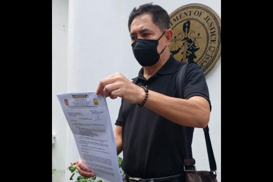  Roy Mabasa, brother of Percy Lapid, holds a copy of the murder complaint against the broadcasters killers at the Department of Justice earlier this morning. Noel Medina, ABS-CBN News 