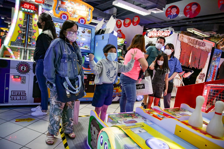 Children spend time with their families at an amusement arcade inside a mall in Mandaluyong City on March 5, 2022. George Calvelo, ABS-CBN News