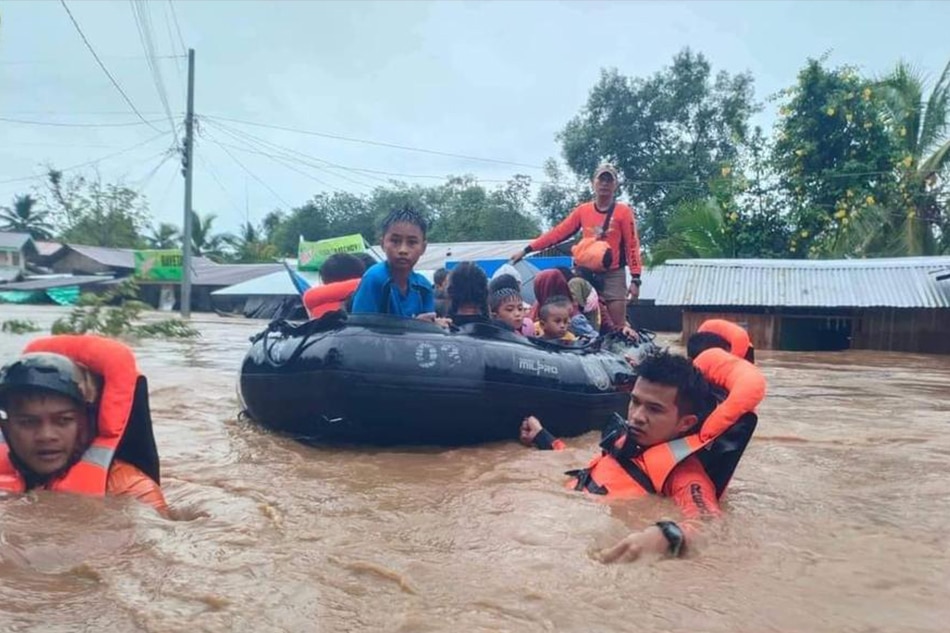 A handout photo made available by Philippine Coast Guard shows its personnel conducting a rescue operation in the flood-hit Parang town, Maguindanao, on October 28, 2022. Philippine Coast Guard, EPA-EFE/file