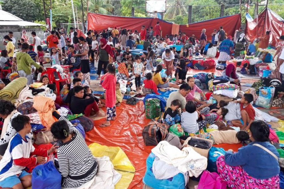 More than a hundred families affected by Tropical Storm Paeng take shelter at Barangay Tamontaka covered court in Datu Odin Sinsuat Municipality in Maguindanao on October 29, 2022. According to Barangay Kagawad Anwar Kasan, the displaced families come from Barangays Badak, Kusiong and Tapian of the same Municipality. Kagawad Kasan and his team serve chicken rice porridge or arroz caldo and bread to children for breakfast.