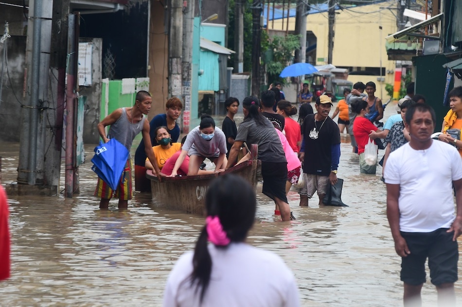 People navigate ankle to knee-deep floodwaters along Antero Soriano Highway in General Trias, Cavite on October 30, 2022. The heavy rains brought by tropical storm Paeng caused massive flooding in different parts of the country. Mark Demayo, ABS-CBN News