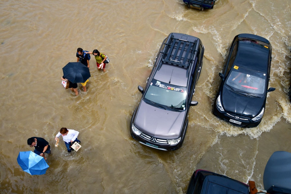 People navigate ankle to knee-deep flood along Antero Soriano Highway in General Trias, Cavite on October 30, 2022. Mark Demayo, ABS-CBN News