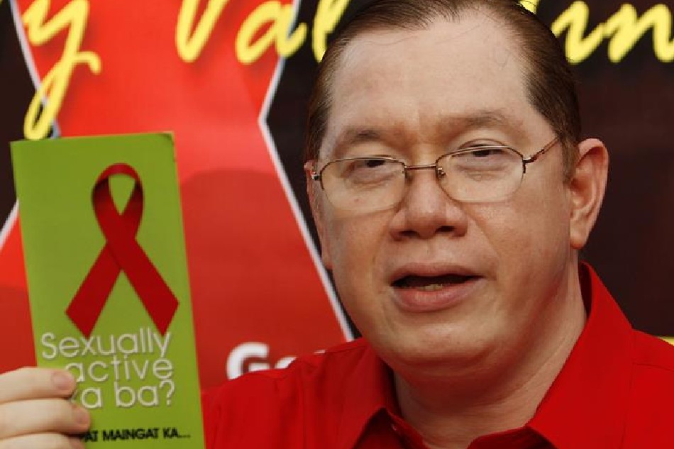 Filipino doctor Eric Tayag, head of the Philippine National Epidemiology Center shows a flyer during condom distribution at a flower market in Manila, Philippines on 13 February 2010. Francis Malasig, EPA