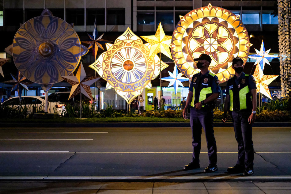 Police officers on duty as one of the main lanterns’ lights went off during the ceremonial lighting of the Christmas lights along Ayala Avenue in Makati on Nov. 3, 2022. George Calvelo, ABS-CBN News